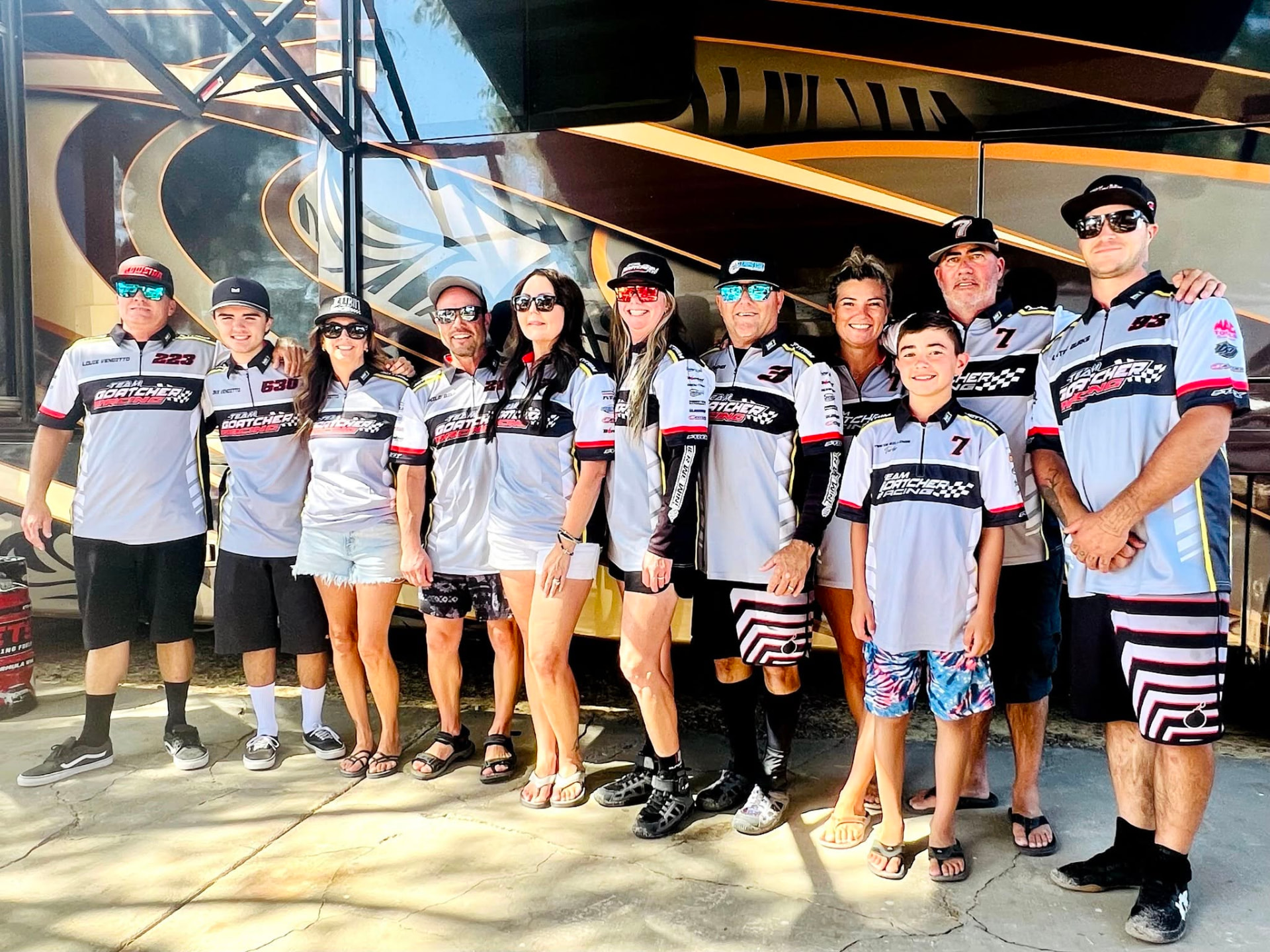 Team Goatcher Racing crew in team shirts in front of the race trailer
