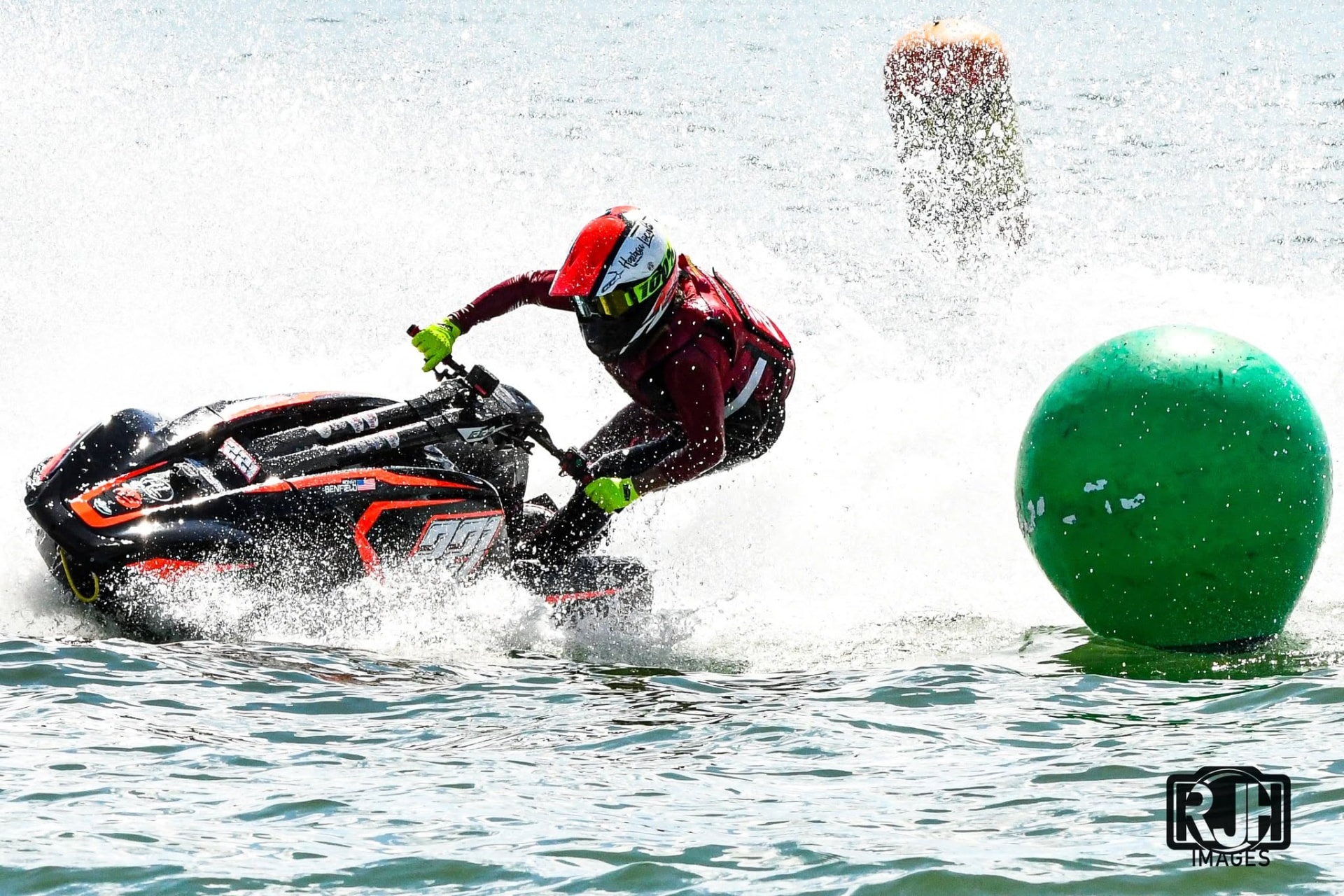 Number 99 jet ski racer carving through a buoy turn