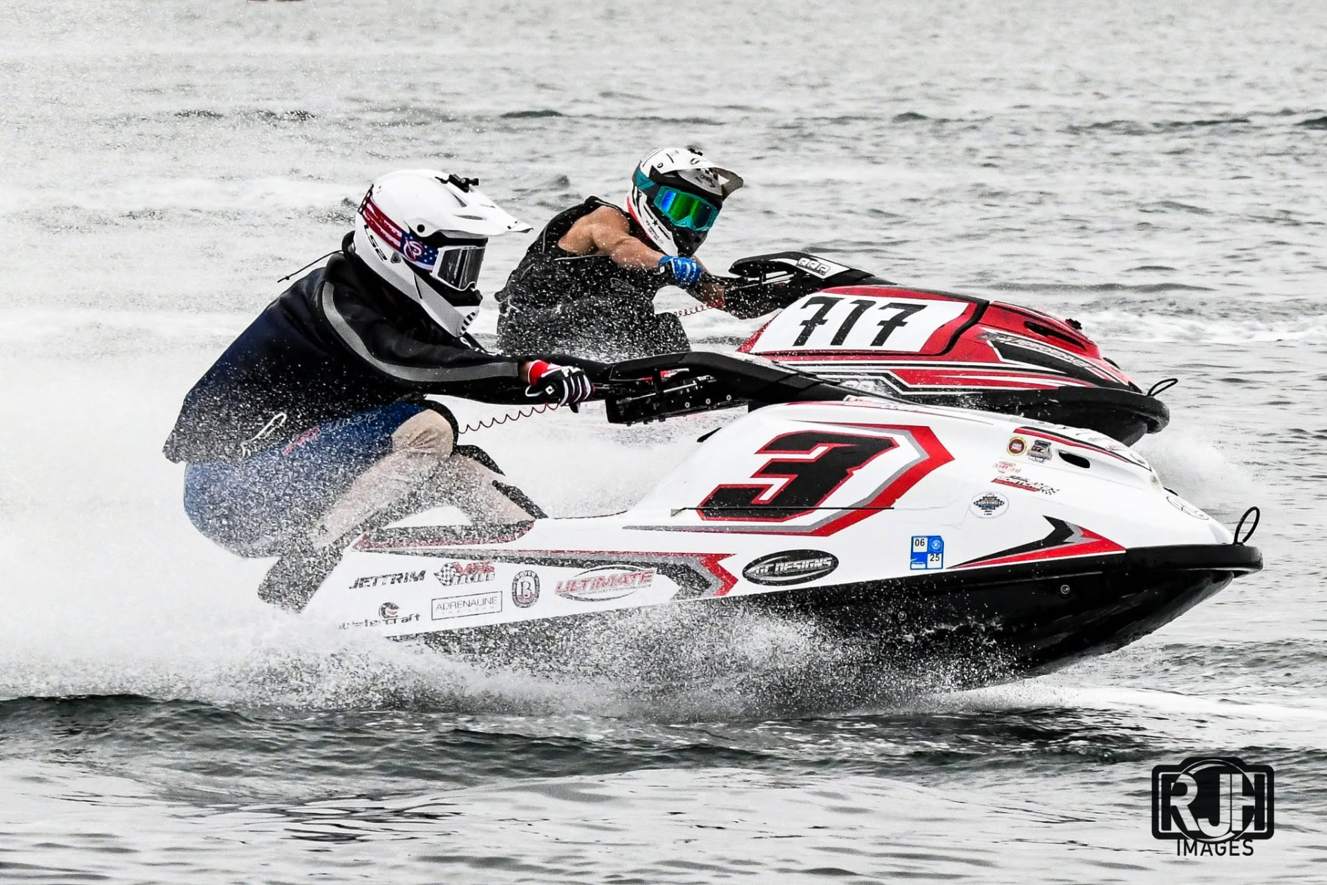 Stand-up jet ski racers battling bar-to-bar in competition